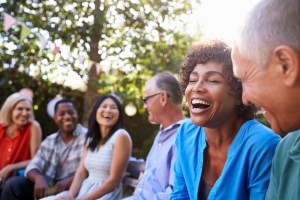 group of friends sitting outside laughing